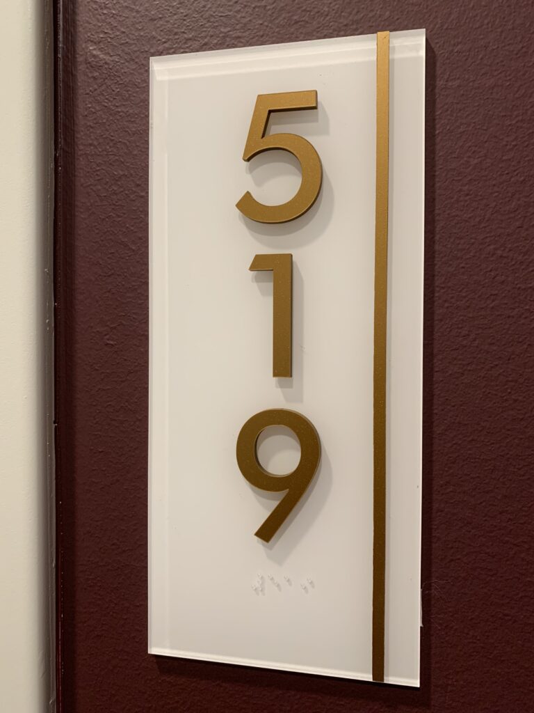 Three-dimensional door number sign displaying numbers 519