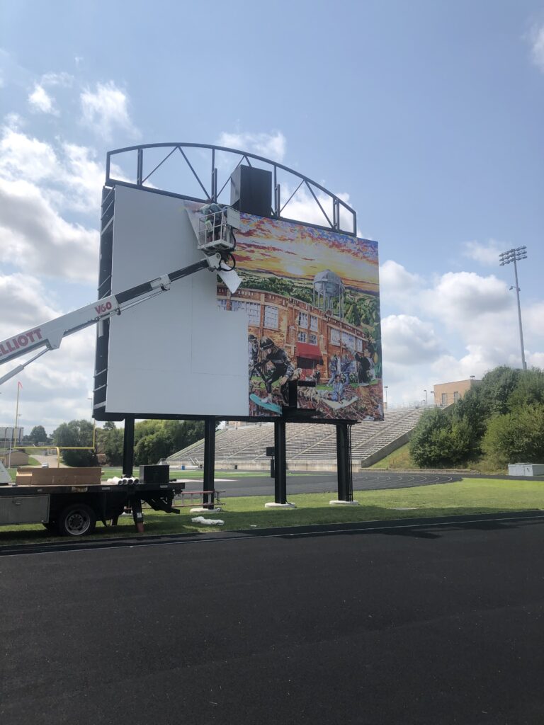 D8 Sign Group installing billboard at Millard South High School football field