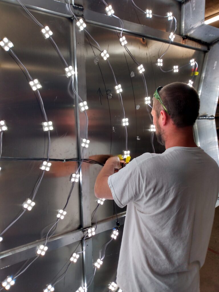 D8 Sign Group employee installing LED lit cabinet sign