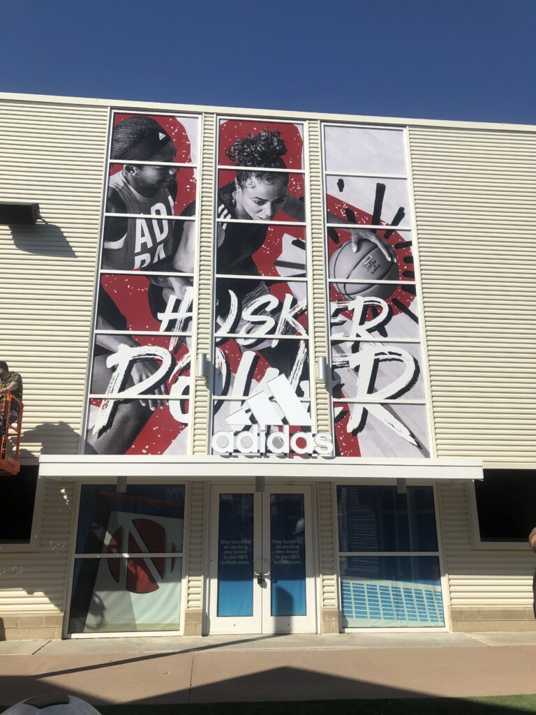 exterior signage for adidas store displaying husker basketball design